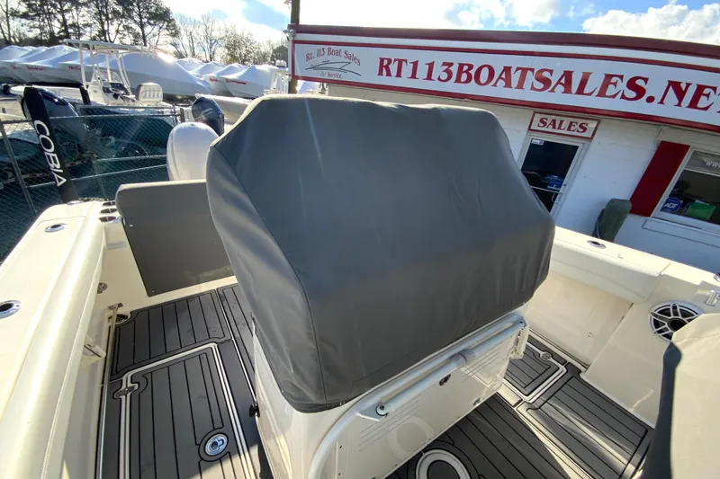 Slide: The Image of 2022 Cobia 280 Center Console boat at dealership, covered console, outdoor display. - 35
