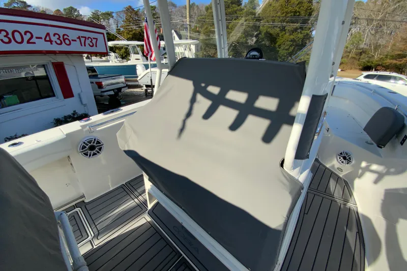 Slide: The Image of 2022 Cobia 280 Center Console boat interior with covered seating and marine speakers. - 36