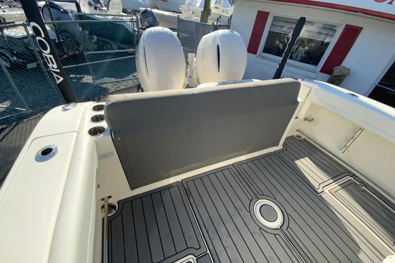 Slide: The Image of 2022 Cobia 280 Center Console boat interior with dual engines and sleek deck design. - 37