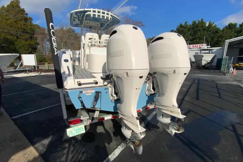 Slide: The Image of 2022 Cobia 280 Center Console boat with dual Yamaha outboard engines. - 8