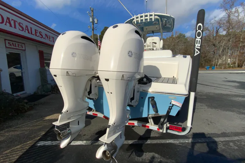 Slide: The Image of 2022 Cobia 280 Center Console boat with dual Yamaha outboard engines at dealership. - 9