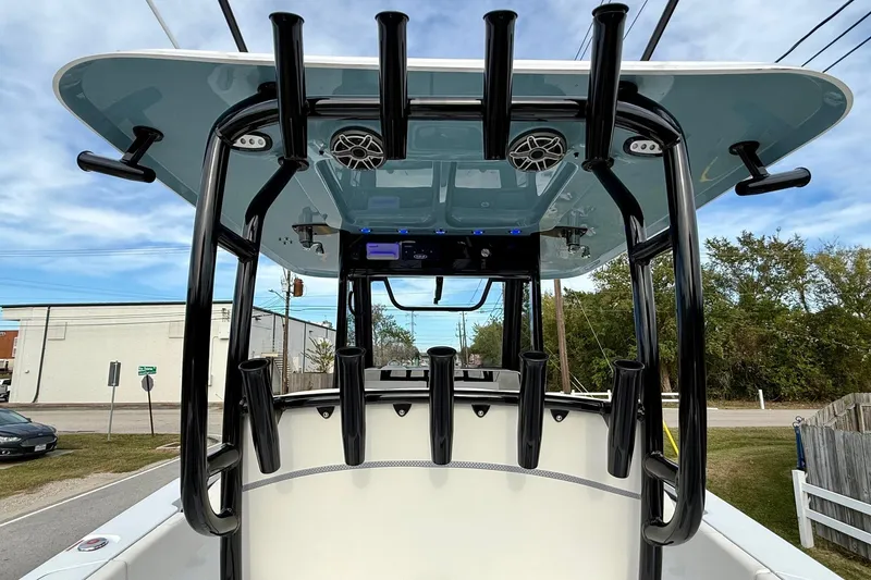 Slide: The Image of 2026 Sea Hunt Gamefish 30 Coffin Box boat with rod holders and speakers, viewed from the rear. - 12