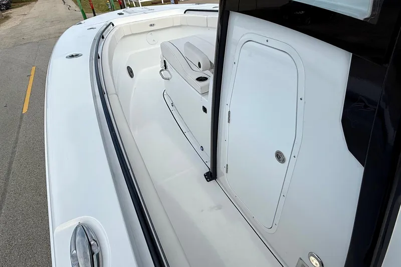 Slide: The Image of 2026 Sea Hunt Gamefish 30 Coffin Box boat interior, featuring sleek white design and storage compartment. - 13