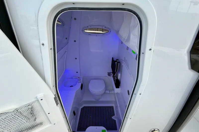 Slide: The Image of 2026 Sea Hunt Gamefish 30 Coffin Box boat interior with modern bathroom amenities. - 14
