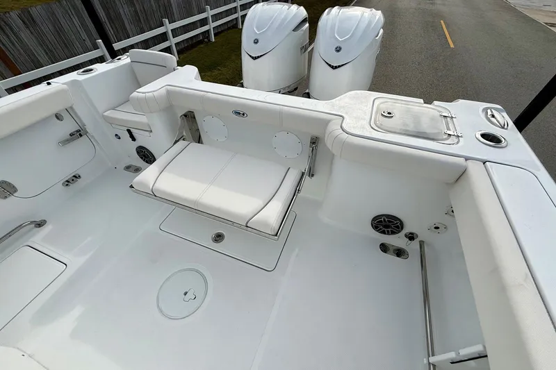 Slide: The Image of 2026 Sea Hunt Gamefish 30 Coffin Box boat interior with seating and dual engines. - 7