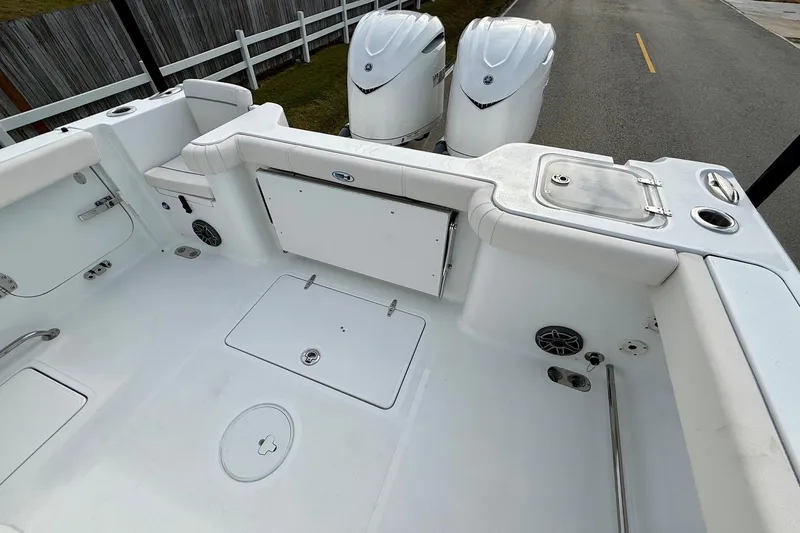 Slide: The Image of 2026 Sea Hunt Gamefish 30 Coffin Box boat interior with dual engines and storage compartments. - 8