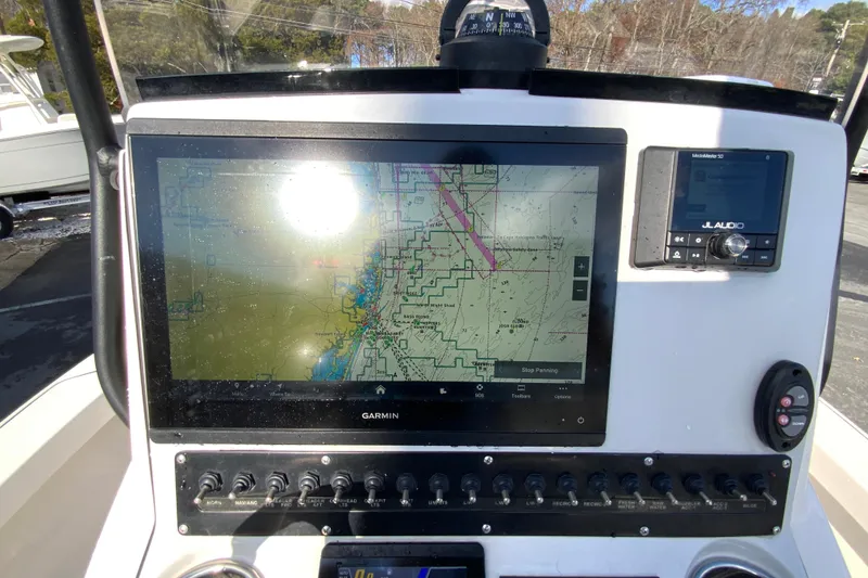 Slide: The Image of 2023 Pathfinder 2300 HPS boat dashboard with Garmin navigation system and JL Audio controls. - 14