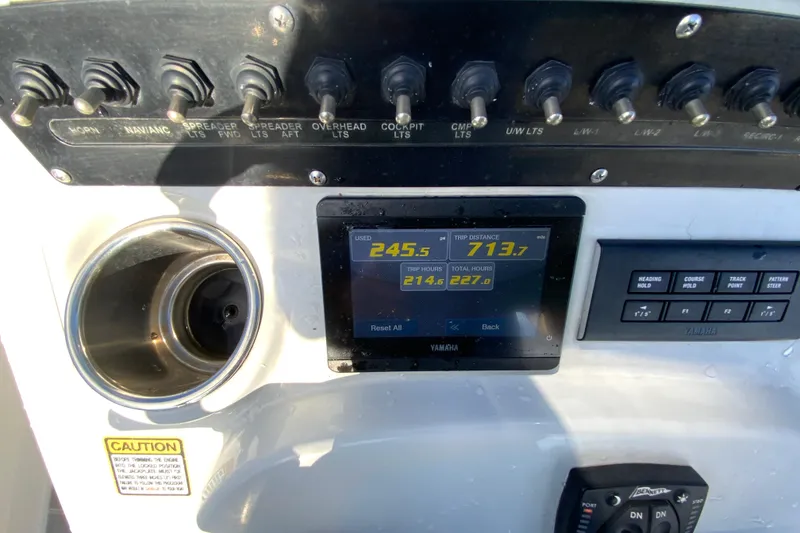 Slide: The Image of Control panel of 2023 Pathfinder 2300 HPS boat with digital display and switches. - 15