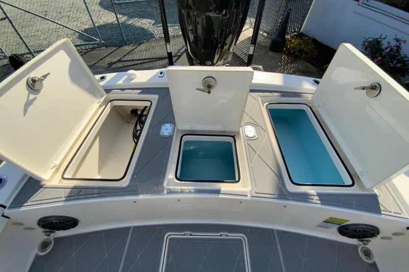 Slide: The Image of 2023 Pathfinder 2300 HPS boat storage compartments open, showcasing interior design. - 17