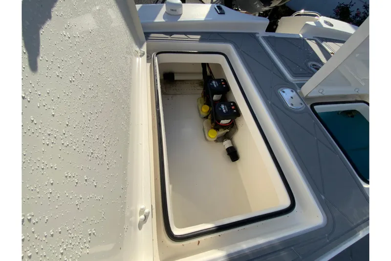 Slide: The Image of 2023 Pathfinder 2300 HPS boat storage compartment with batteries and wiring. - 18