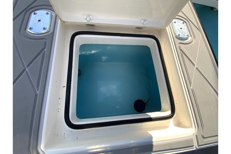 Slide: The Image of Open storage compartment on 2023 Pathfinder 2300 HPS boat, featuring a clean interior. - 19