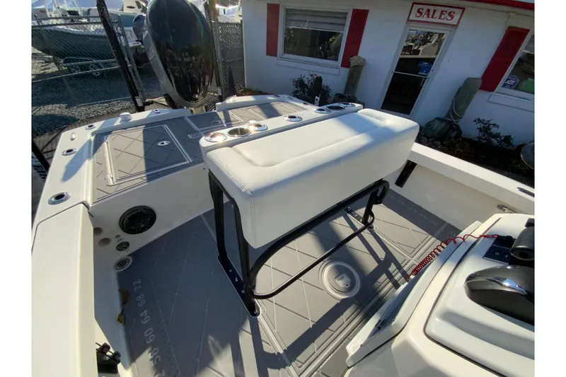 Slide: The Image of 2023 Pathfinder 2300 HPS boat interior with seating and control panel near sales office. - 22