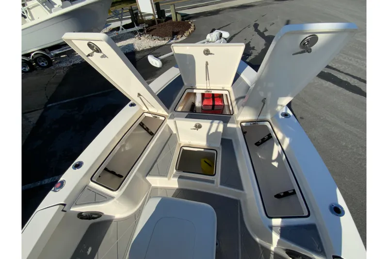 Slide: The Image of 2023 Pathfinder 2300 HPS boat with open storage compartments and seating area. - 24