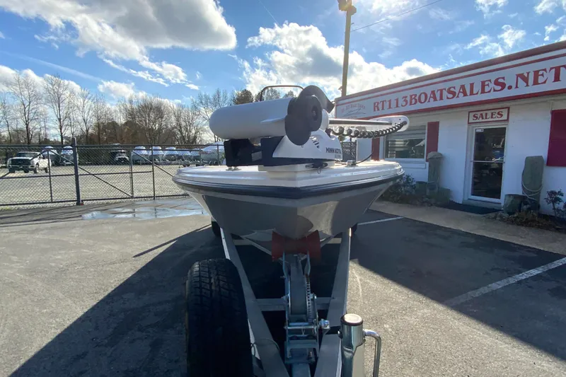 Slide: The Image of 2023 Pathfinder 2300 HPS boat on trailer at dealership under blue sky. - 4
