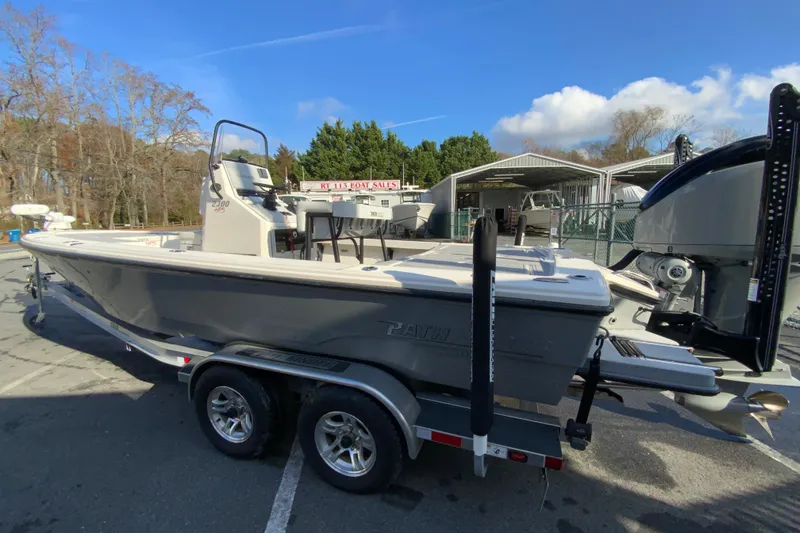 Slide: The Image of 2023 Pathfinder 2300 HPS boat on trailer at dealership, sunny day. - 7