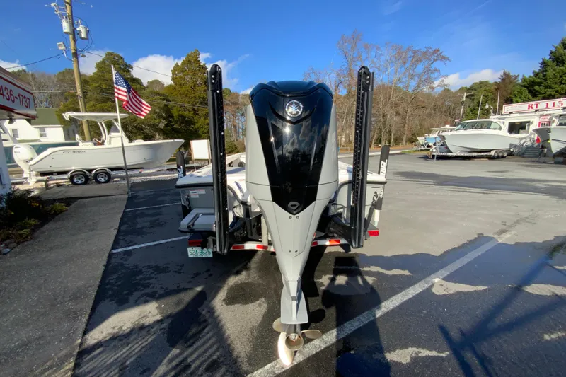 Slide: The Image of 2023 Pathfinder 2300 HPS boat with powerful outboard motor in a dealership lot. - 9