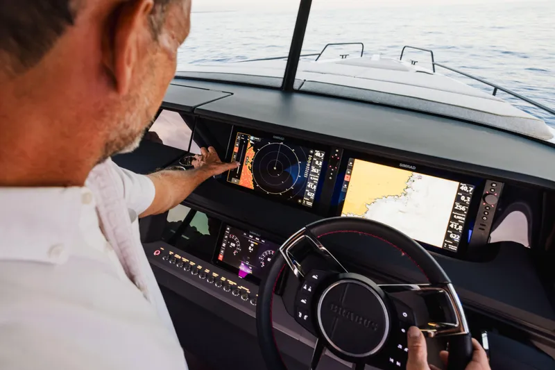 Slide: The Image of Man navigating Axopar 45 XC AC Sandstone Lithium 2026 with advanced dashboard displays. - 4