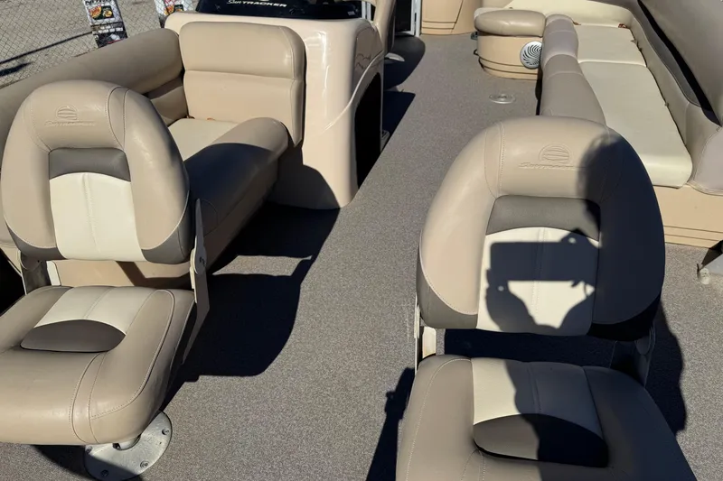 Slide: The Image of 2016 Sun Tracker Fishin' Barge 20 DLX interior with beige seating and carpeted floor. - 3