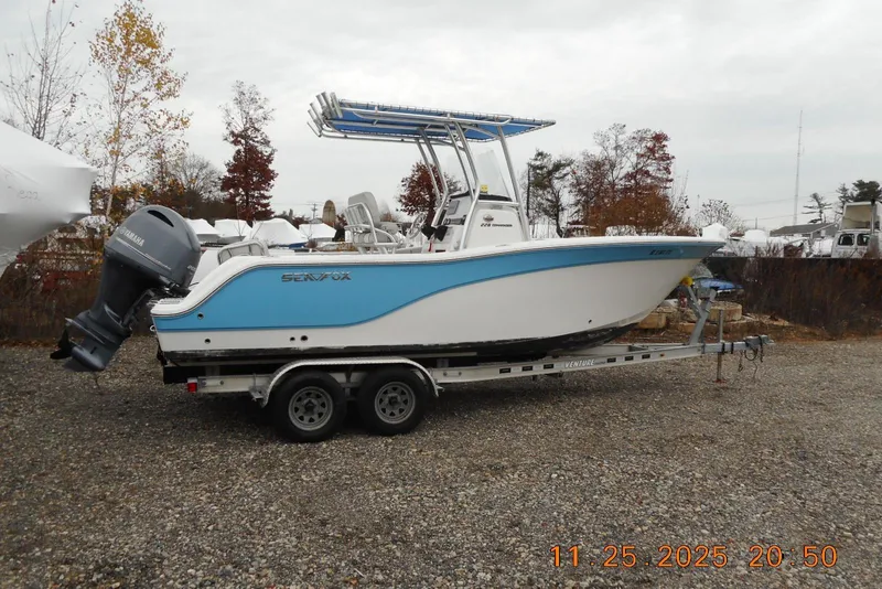 The Image of 2021 Sea Fox 228 Commander boat on trailer, parked outdoors on gravel. - 1