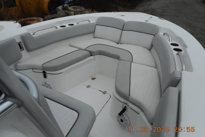 Slide: The Image of 2021 Sea Fox 228 Commander boat interior with cushioned seating and cup holders. - 15