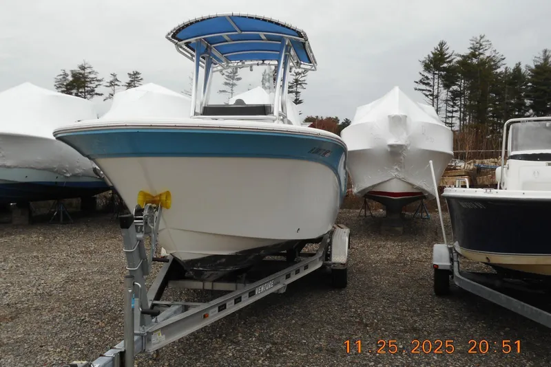 Slide: The Image of 2021 Sea Fox 228 Commander boat on trailer, parked outdoors with other covered boats. - 4