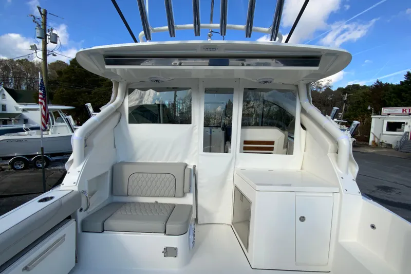Slide: The Image of 2026 Pursuit DC 326 Dual Console boat interior with seating and storage. - 12