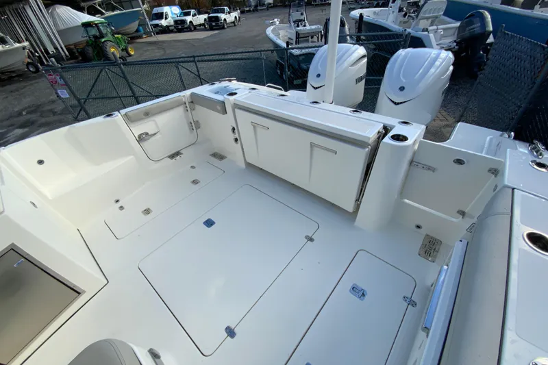 Slide: The Image of 2026 Pursuit DC 326 Dual Console boat interior with storage compartments and Yamaha engines. - 14