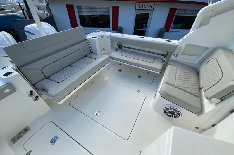 Slide: The Image of 2026 Pursuit DC 326 Dual Console boat interior with cushioned seating and storage compartments. - 15