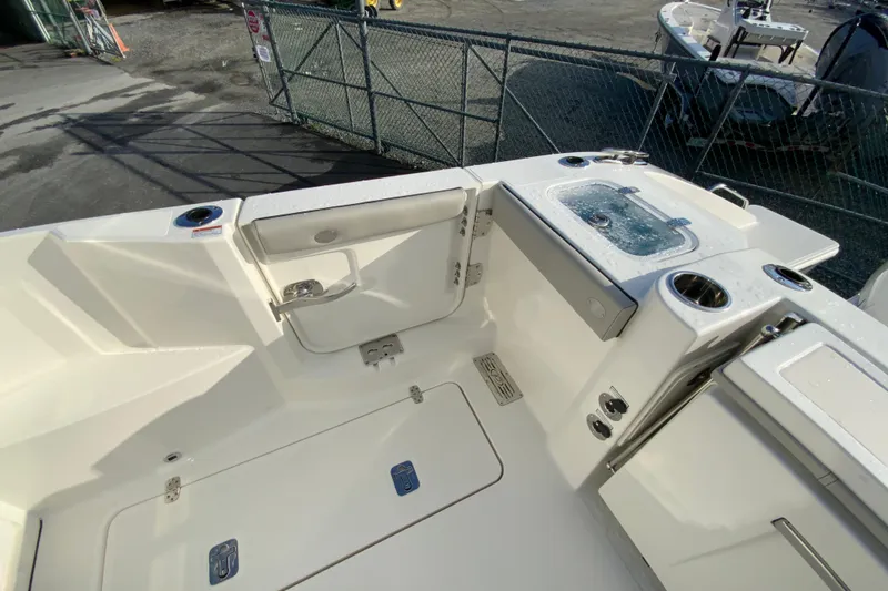 Slide: The Image of 2026 Pursuit DC 326 Dual Console boat interior with seating and storage compartments. - 16