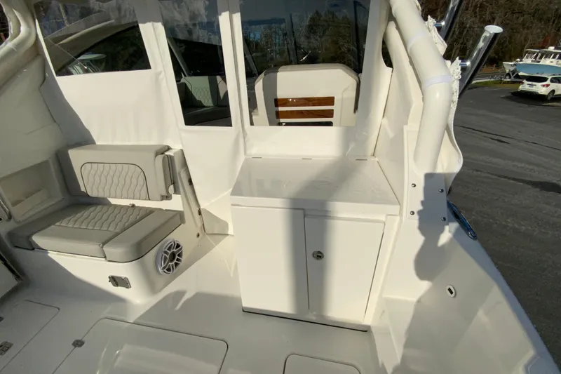 Slide: The Image of 2026 Pursuit DC 326 Dual Console interior with seating and storage. - 18