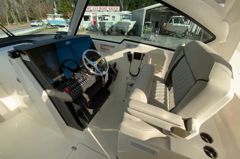 Slide: The Image of 2026 Pursuit DC 326 Dual Console interior with modern helm and comfortable seating. - 20