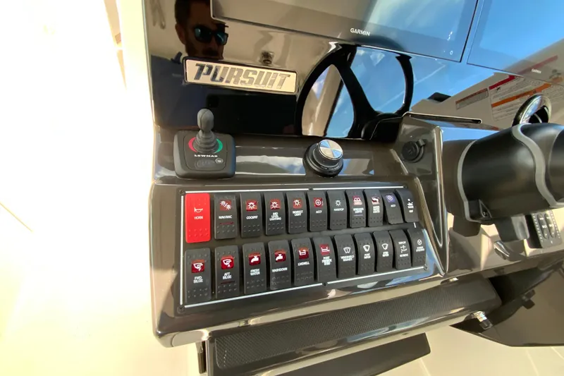 Slide: The Image of 2026 Pursuit DC 326 Dual Console dashboard with control switches and joystick. - 23