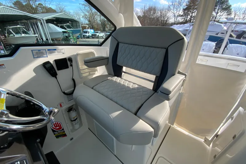 Slide: The Image of Captain's seat in 2026 Pursuit DC 326 Dual Console boat, featuring quilted upholstery. - 25
