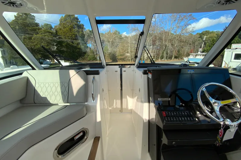 Slide: The Image of 2026 Pursuit DC 326 Dual Console interior with helm and seating area. - 30