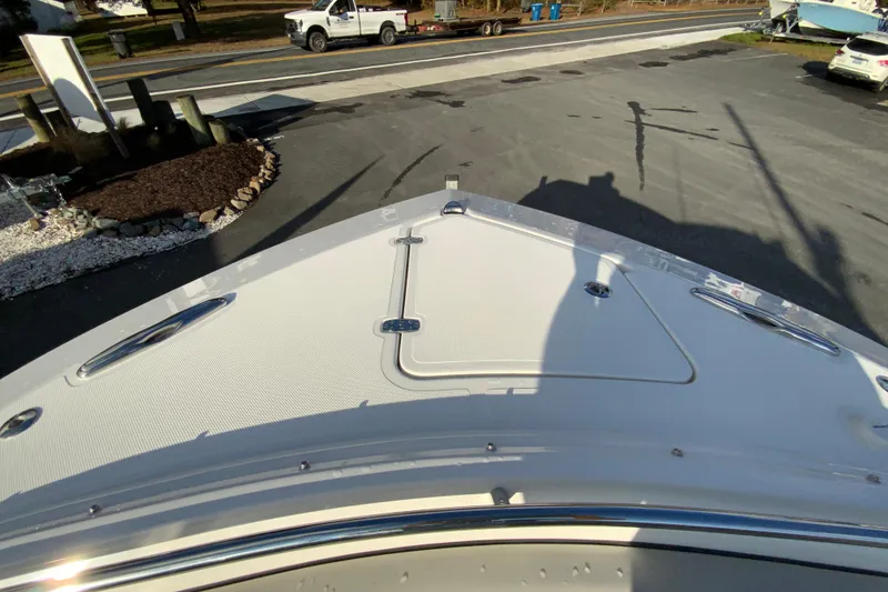 Slide: The Image of 2026 Pursuit DC 326 Dual Console boat bow view in a parking area. - 33