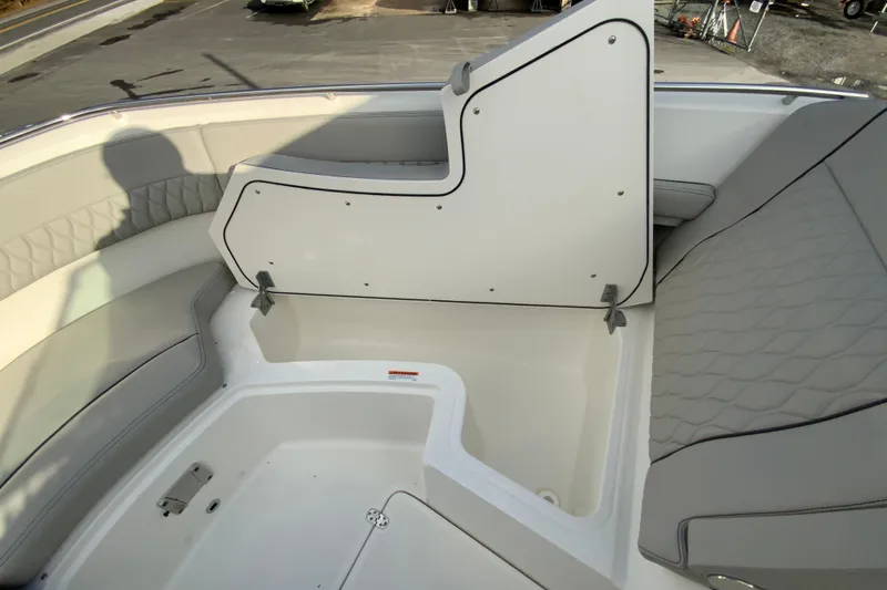 Slide: The Image of 2026 Pursuit DC 326 Dual Console boat interior with open storage compartment. - 37