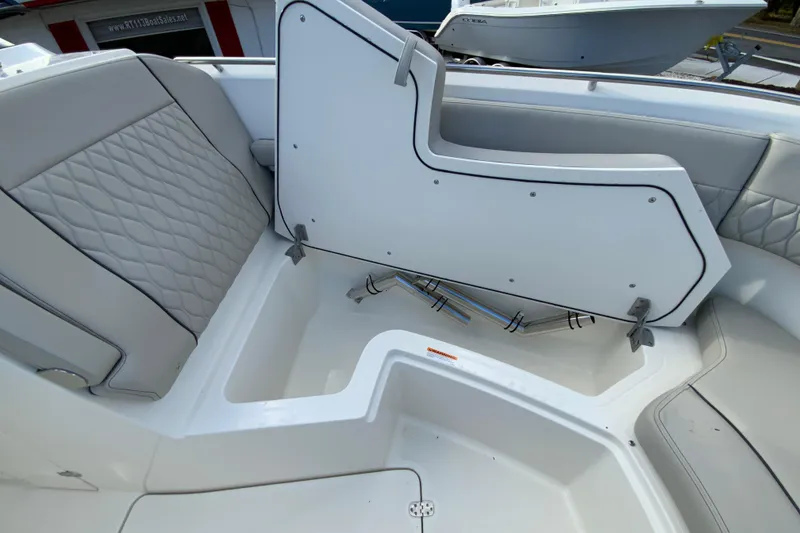 Slide: The Image of 2026 Pursuit DC 326 Dual Console boat interior with storage compartment open. - 38