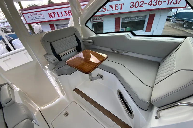 Slide: The Image of 2026 Pursuit DC 326 Dual Console interior with seating and wooden table. - 41