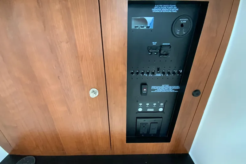 Slide: The Image of Electrical control panel on 2026 Pursuit DC 326 Dual Console boat, featuring switches and outlets. - 45