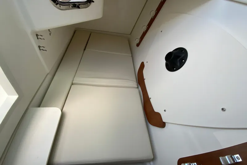 Slide: The Image of 2026 Pursuit DC 326 Dual Console cabin interior with cushioned seating and modern design. - 47