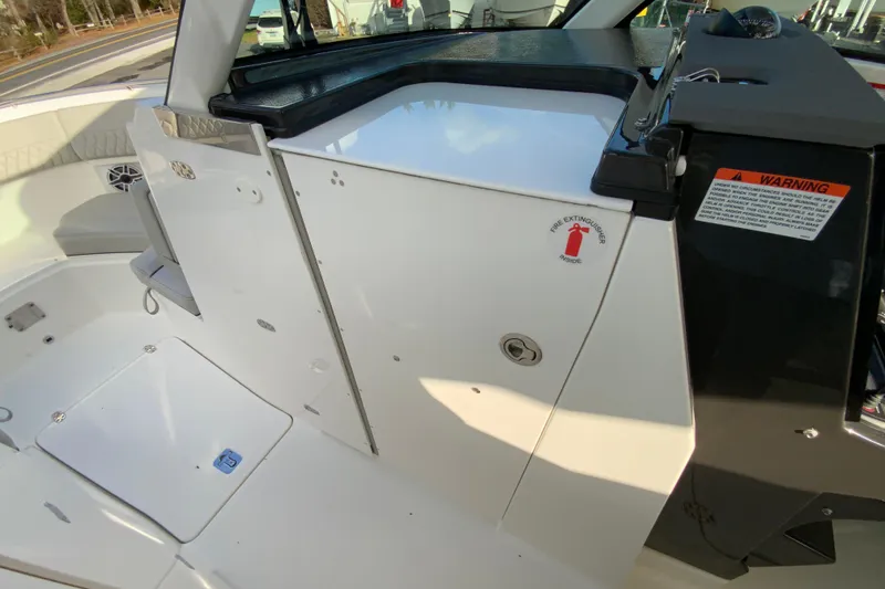 Slide: The Image of 2026 Pursuit DC 326 Dual Console interior with safety features and storage compartments. - 48