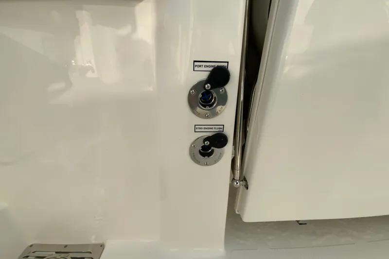 Slide: The Image of 2026 Pursuit DC 326 Dual Console engine flush ports on white boat exterior. - 55