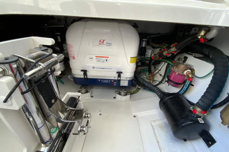 Slide: The Image of Engine compartment of 2026 Pursuit DC 326 Dual Console boat with generator and wiring. - 59