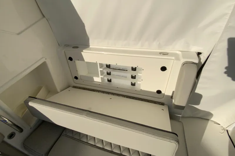 Slide: The Image of 2026 Pursuit DC 326 Dual Console boat interior seating and storage area. - 61