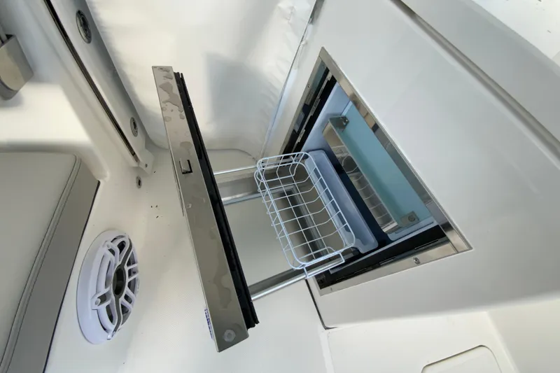 Slide: The Image of 2026 Pursuit DC 326 Dual Console boat interior with open storage compartment. - 64