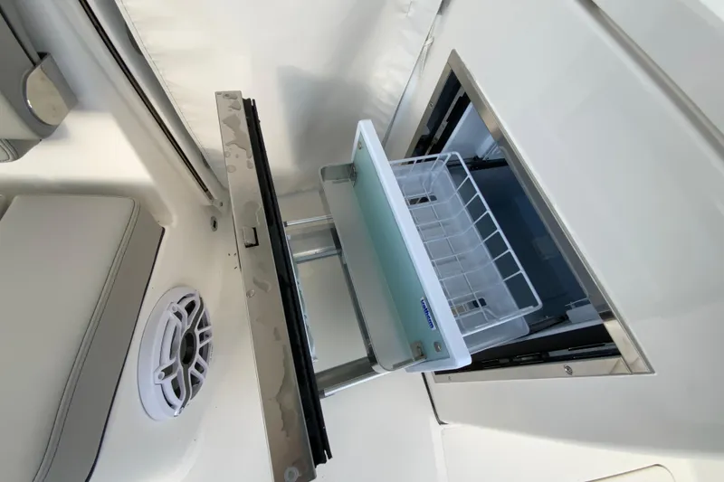 Slide: The Image of 2026 Pursuit DC 326 Dual Console boat interior with open storage compartment. - 65