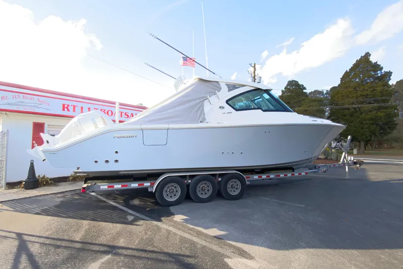 Slide: The Image of 2026 Pursuit DC 326 Dual Console boat on trailer at dealership. - 69