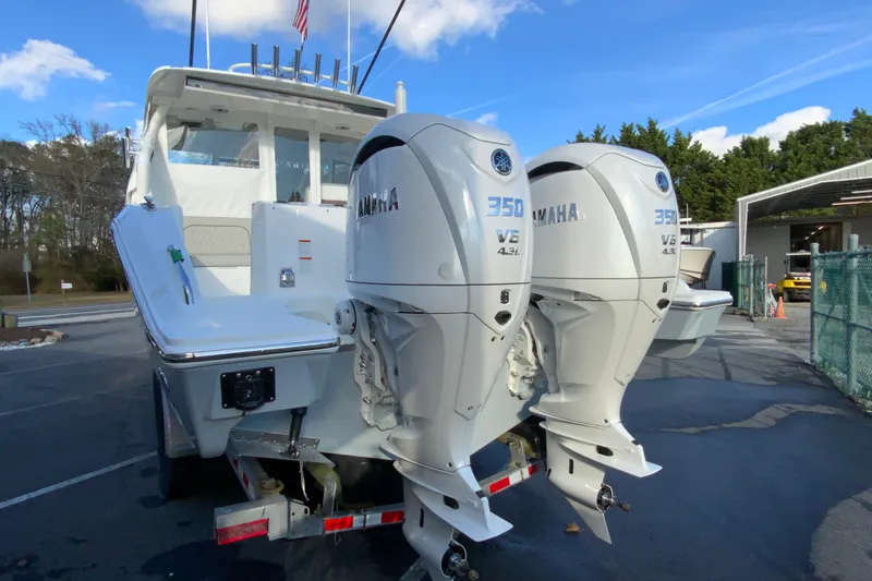 Slide: The Image of 2026 Pursuit DC 326 Dual Console with twin Yamaha 350 V8 engines, parked outdoors. - 8