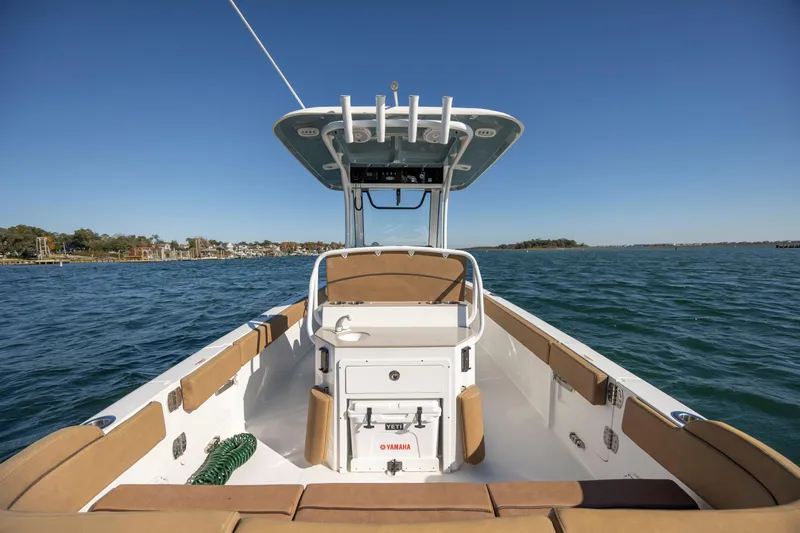 Slide: The Image of 2021 Sea Hunt Escape 27 boat on open water, featuring spacious seating and modern design. - 10