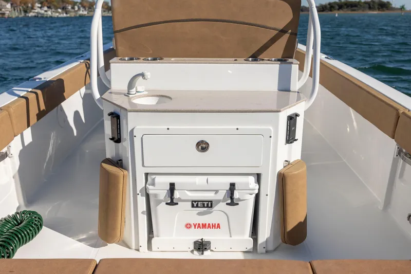 Slide: The Image of 2021 Sea Hunt Escape 27 boat interior with sink and Yeti cooler. - 11